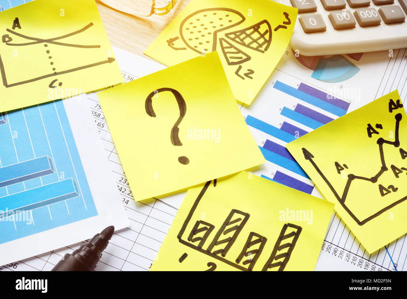 Question Mark On Financial Performance Question mark on stick, business papers and financial charts Stock ...
