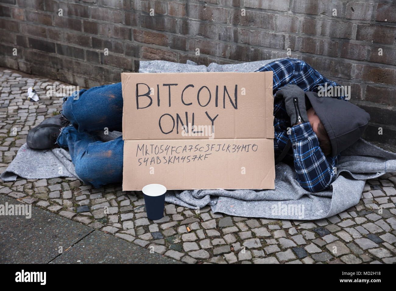 Beggar Sleeping On Street With Bitcoin Only Text On Cardboard Stock Photo -  Alamy