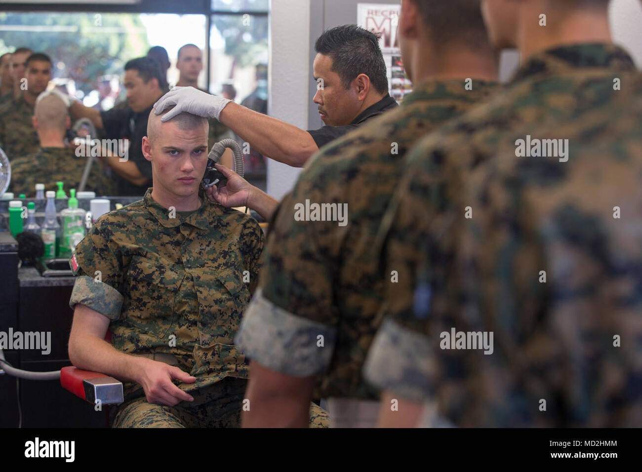 Recruits from Delta Company, 1st Recruit Training Battalion, wait to receive haircuts at Marine Corps Recruit Depot San Diego, March 27. Recruits receive haircuts regularly during training to create uniformity and promote camaraderie. Annually, more than 17,000 males recruited from the Western Recruiting Region are trained MCRD San Diego. Mike Company is scheduled to graduate June 1. Stock Photo