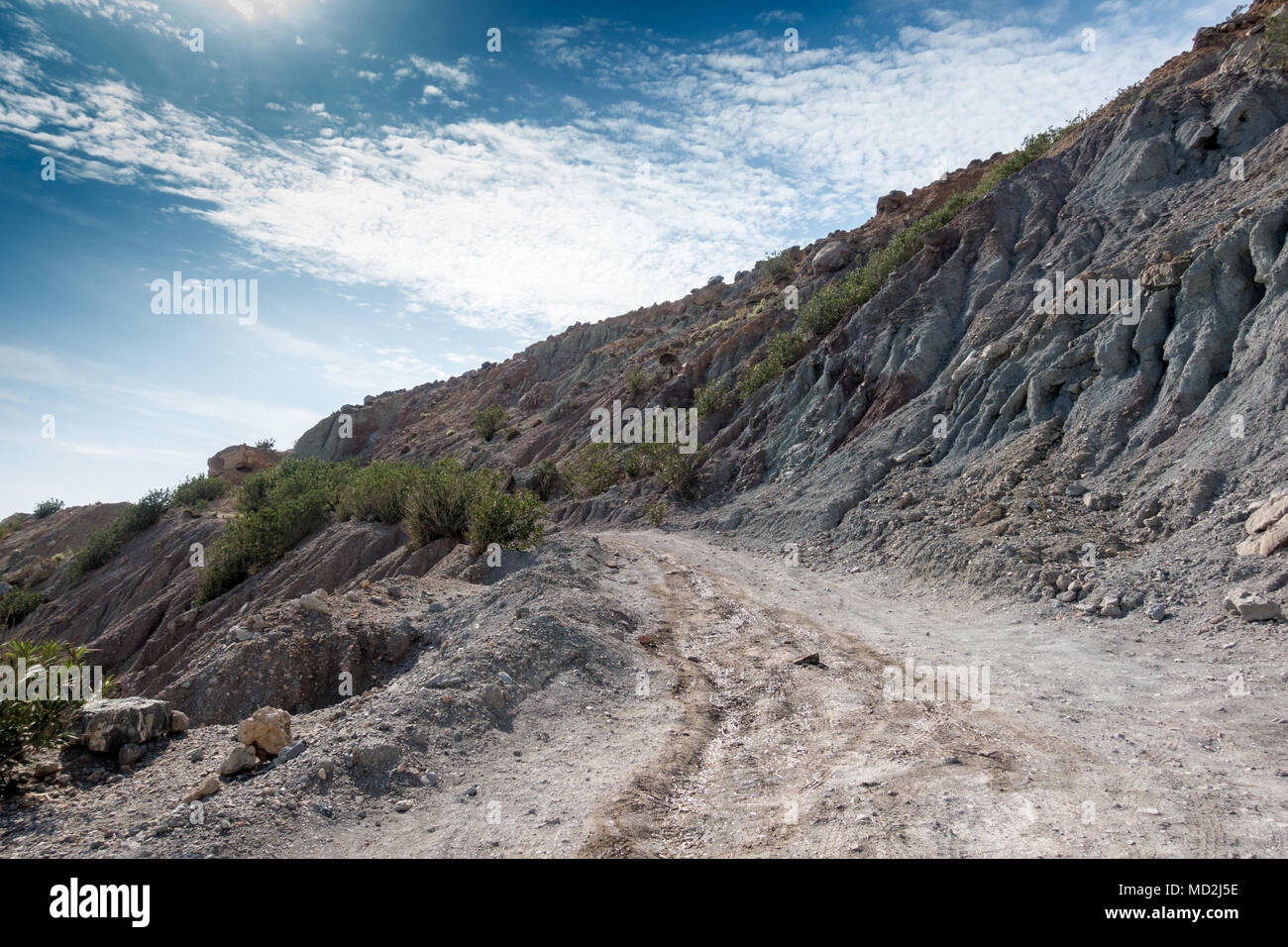 Dirt road and rocky mountain against sky, Crete, Greece Stock Photo