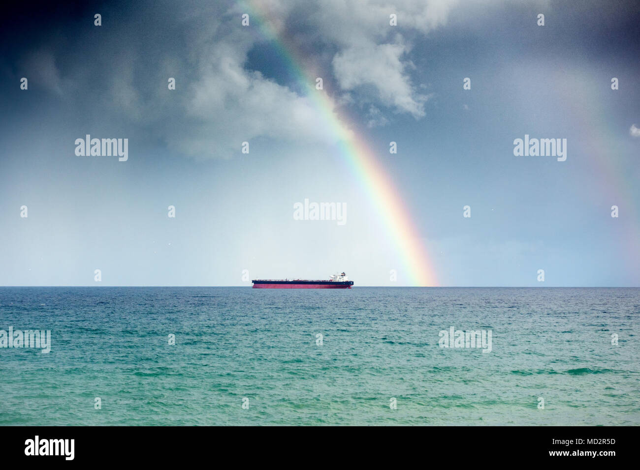 Distant view of boat and rainbow in sky, Greece Stock Photo - Alamy