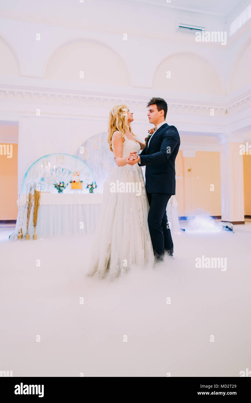 Happy young bride and groom dance in the wedding hall Stock Photo - Alamy