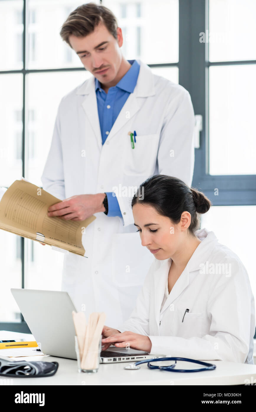 Doctor And Pharmacist Checking Information On A Laptop In A Hospital Stock Photo Alamy