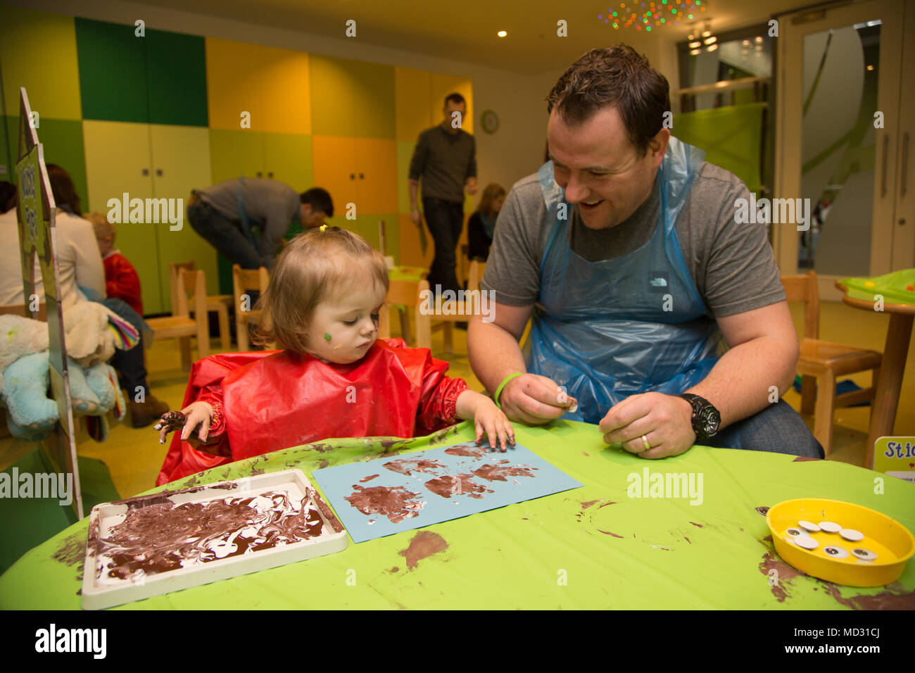 Father and daughter at messy play Stock Photo