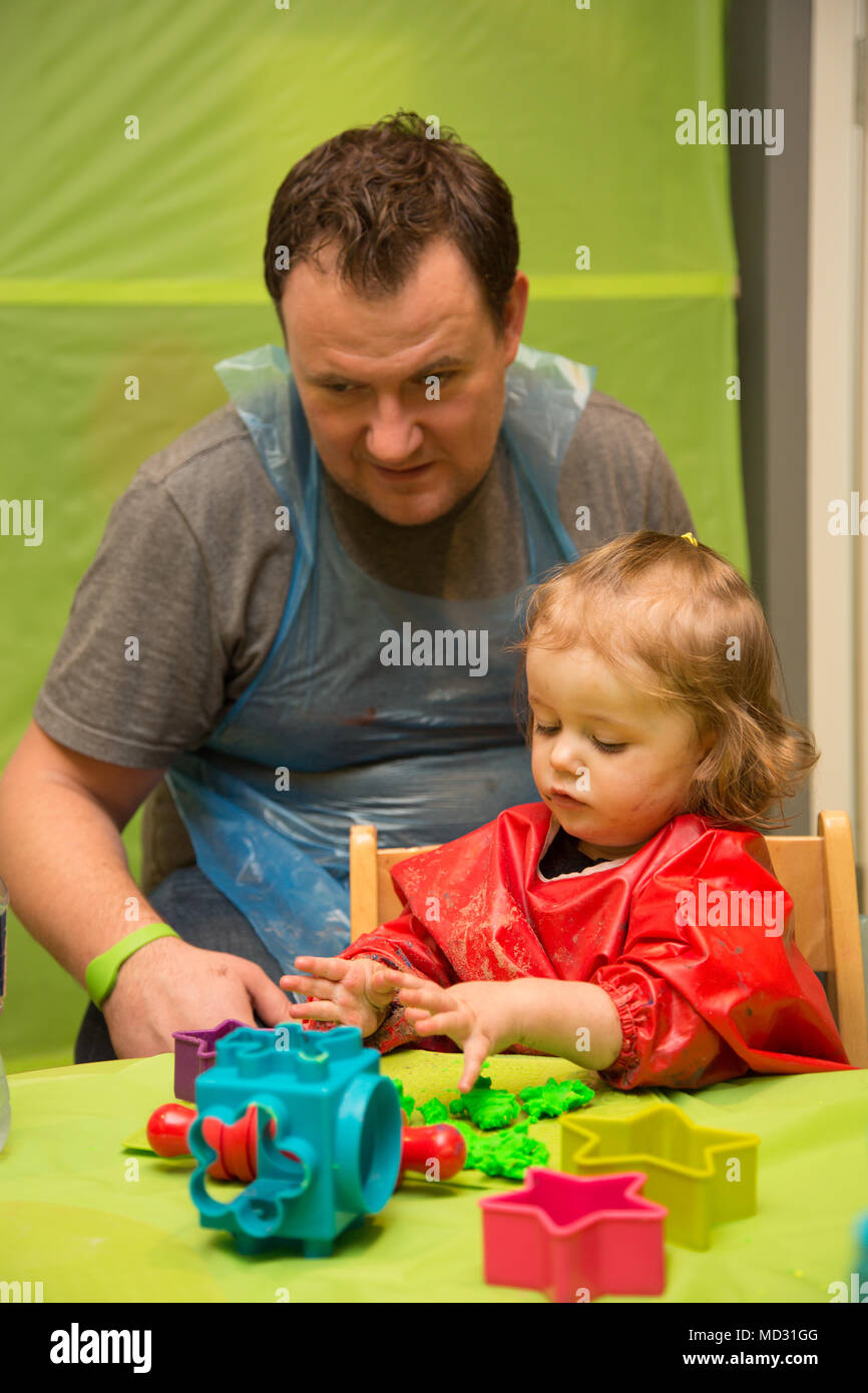 Father and daughter at messy play Stock Photo