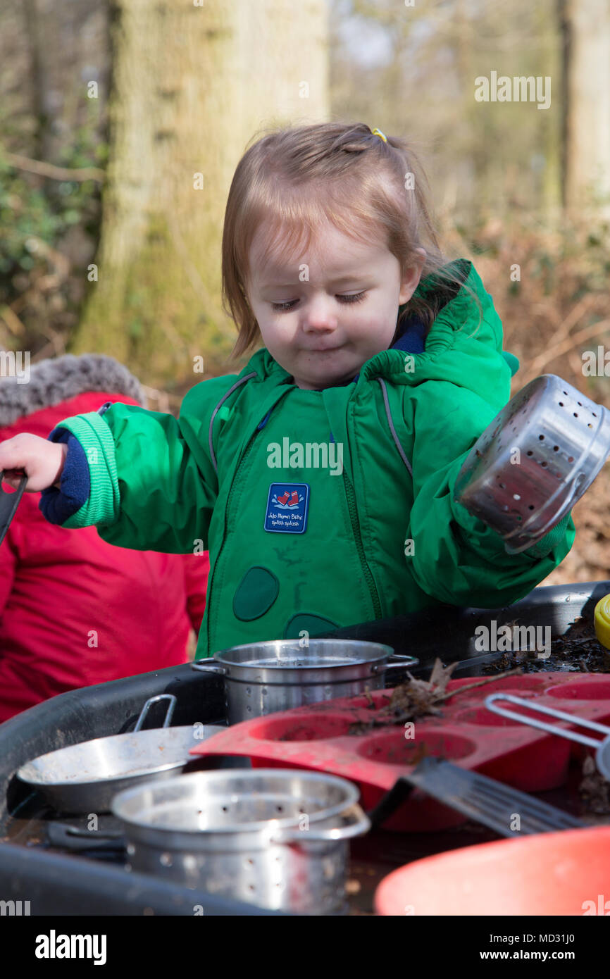 Toddlers playing with a mud kitchen Stock Photo