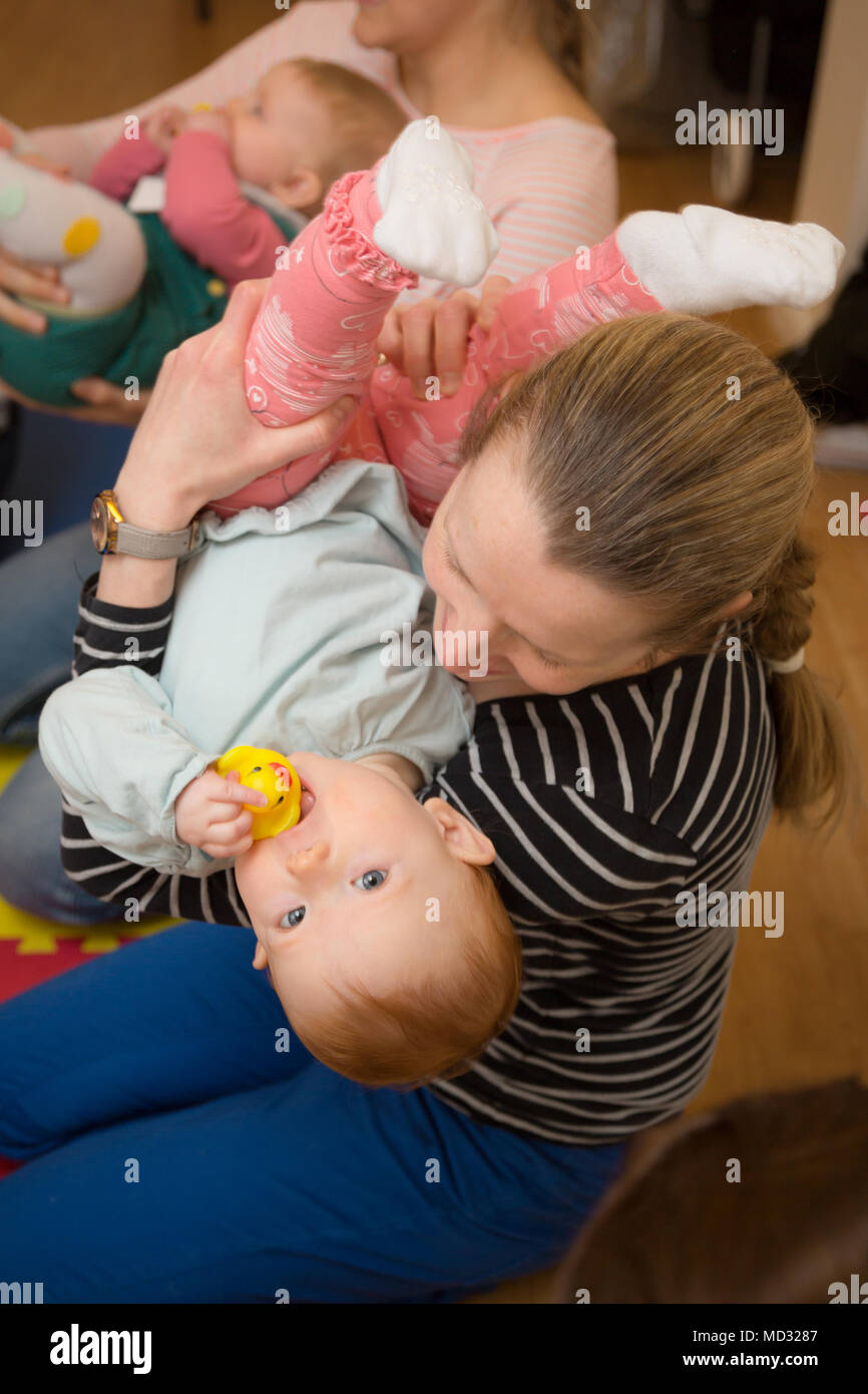 Mother holding her toddler child, Stock Photo