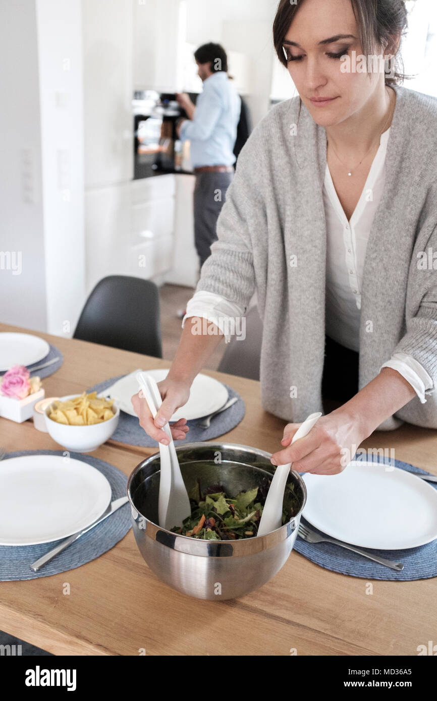Vegetarian lunch party-woman prepaing  sald Stock Photo