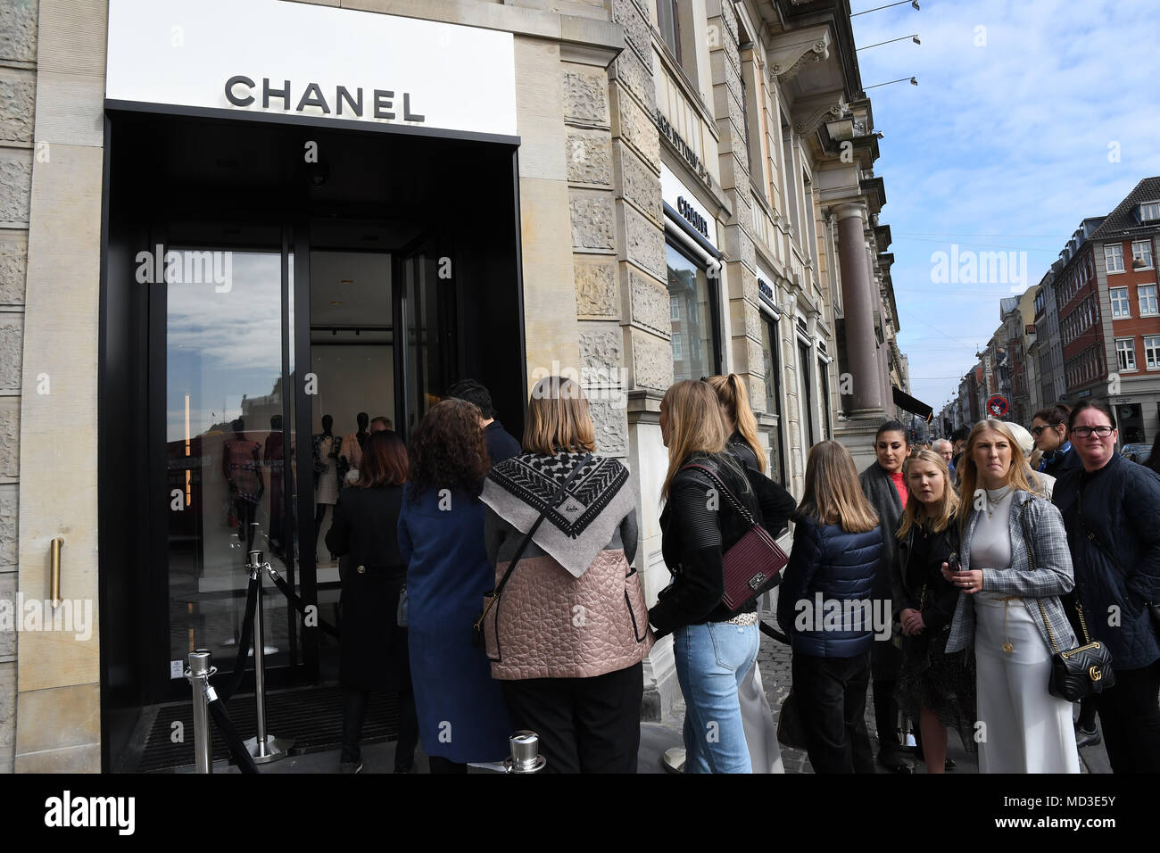 Copenhagen, Denmark. 18th Apr, 2018. French chain Chanel opens its first shop ever in Copenhagen first consumer with Chanel shopping bag and consumer waiting outside in line at chanel shop to shopping today on its first day of Chanel business in Copenhagen Denmaerk.. (Photo.Francis Joseph Dean / Deanpictures. Credit: Francis Joseph Dean / Deanpictures/Alamy Live News Stock Photo