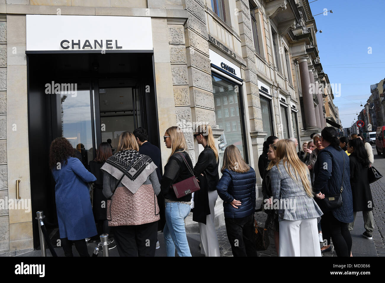 Copenhagen, Denmark. 18th Apr, 2018. French chain Chanel opens its first shop ever in Copenhagen first consumer with Chanel shopping bag and consumer waiting outside in line at chanel shop to shopping today on its first day of Chanel business in Copenhagen Denmaerk.. (Photo.Francis Joseph Dean / Deanpictures. Credit: Francis Joseph Dean / Deanpictures/Alamy Live News Stock Photo