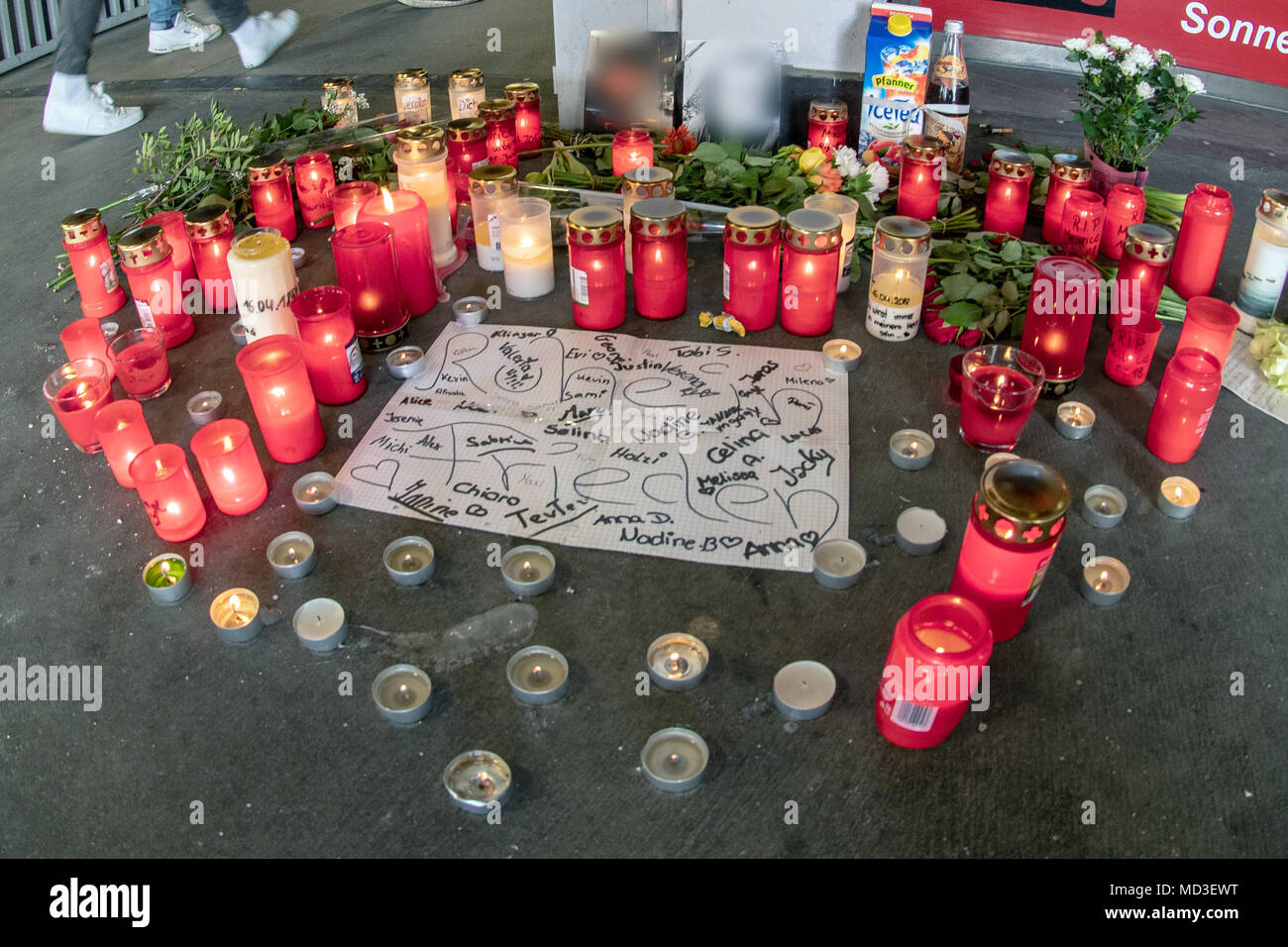 18 April 2018, Passau, Germany: Candles and flowers lying in front of an underground pedestrian passageway. According to an autopsy report by the police on Wednesday, the boy suffocated on his own blood during the fight an underground pedestrian passageway. Photo: Armin Weigel/dpa Stock Photo