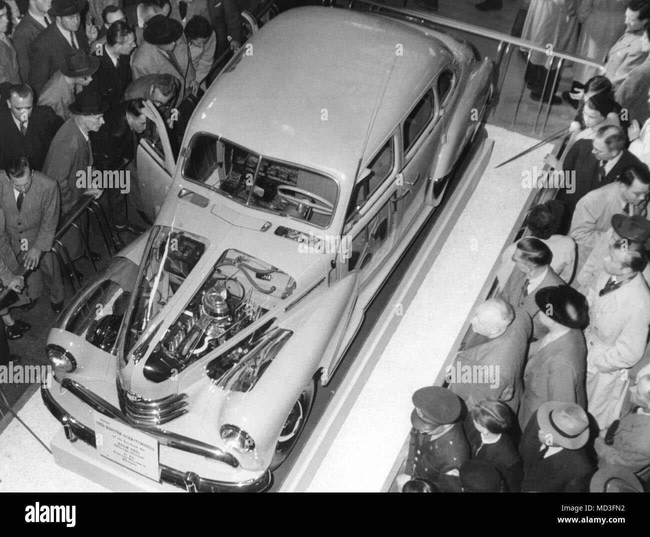 Visitors marvel at a model of an Opel Kapitan car at the 36th International Motor Show in Frankfurt am Main on 22.03.1953, where various parts of the body were cut out and replaced with Plexiglas. So the engine, the suspension and the circuit of the car are also visible from the outside. After the exhibition, this model will be exhibited at the Deutsches Museum in Munich. Photo: Heinz-Jurgen Gottert     (c) dpa - report     | usage worldwide Stock Photo