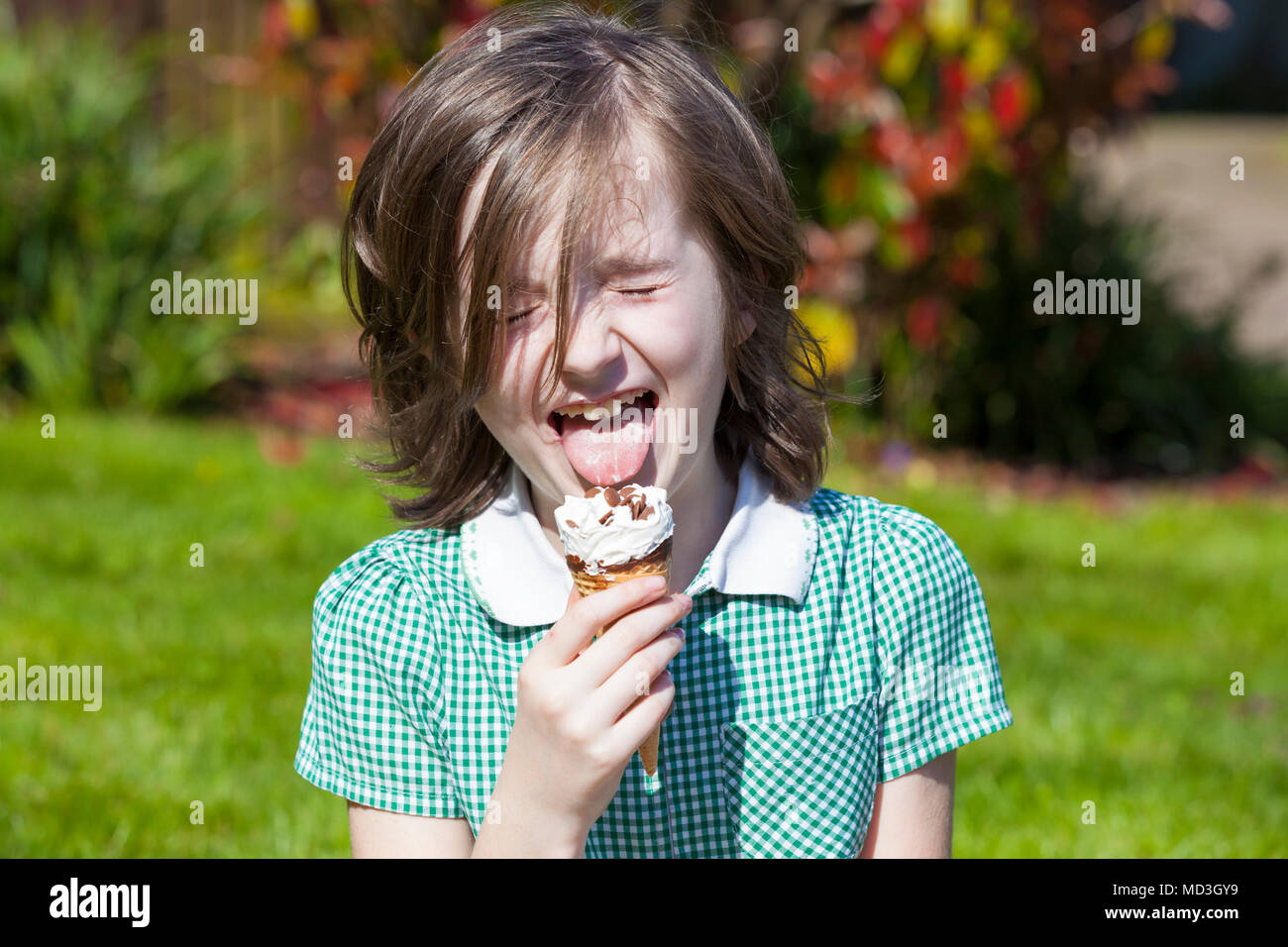 Ashford, Kent, UK. 18th Apr, 2018. UK Weather: A very hot day in Ashford, Kent this afternoon with temperatures expected to exceed 25°C in some parts of the country. Takara, an 8 year old girl enjoys an ice cream after just finishing school for the day. © Paul Lawrenson 2018, Photo Credit: PAL Images / Alamy Live News Stock Photo