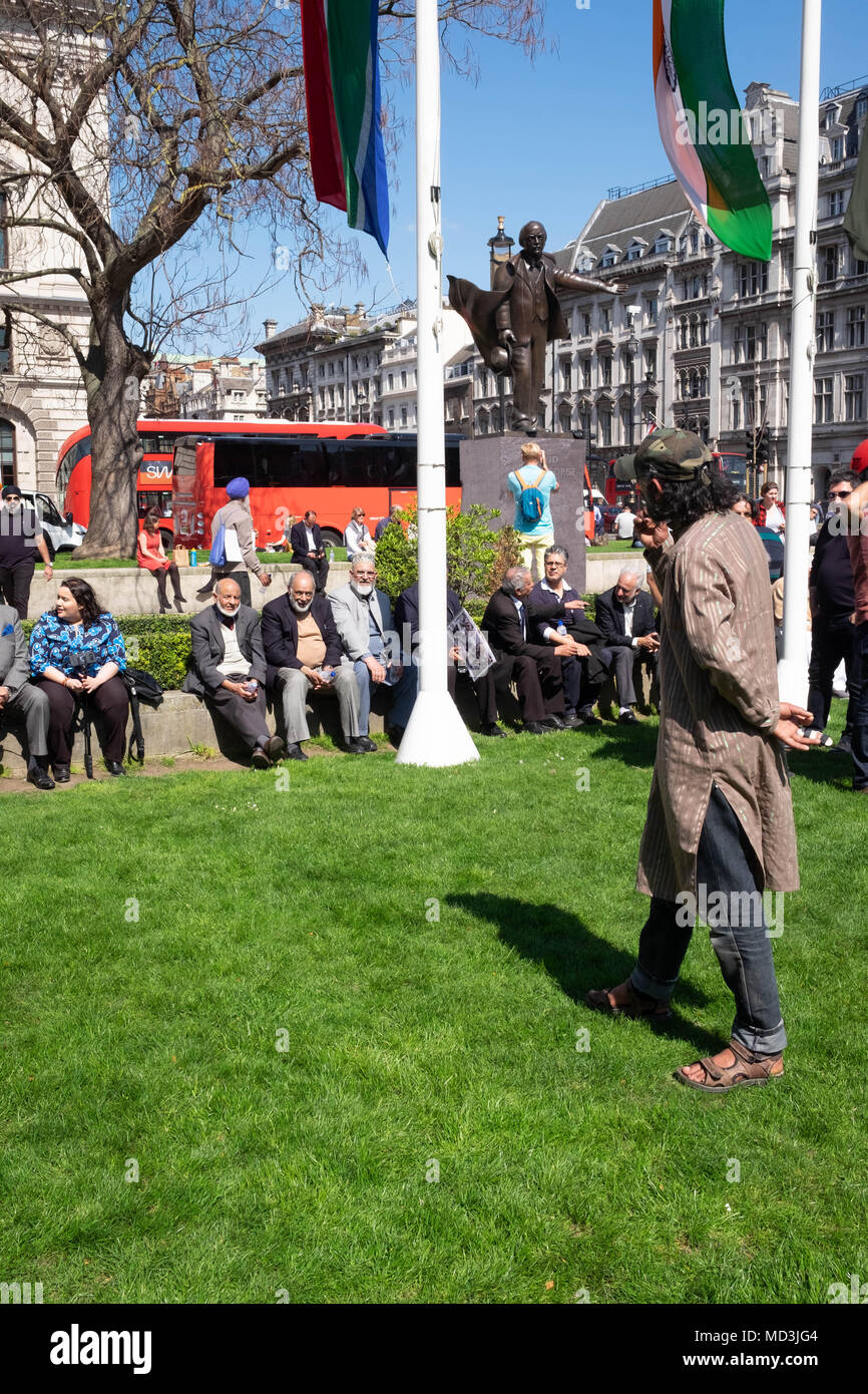 London, UK. 18th April, 2018. London Protests: The elders, known respectfully as Uncles by their community, sit beneath the Indian flag to protect it a rumour spread through the crowd the flag was going to be targeted. Around the elders, hundreds of very loud protestors gathered in Lo Credit: Tim Ring/Alamy Live News Credit: Tim Ring/Alamy Live News Stock Photo