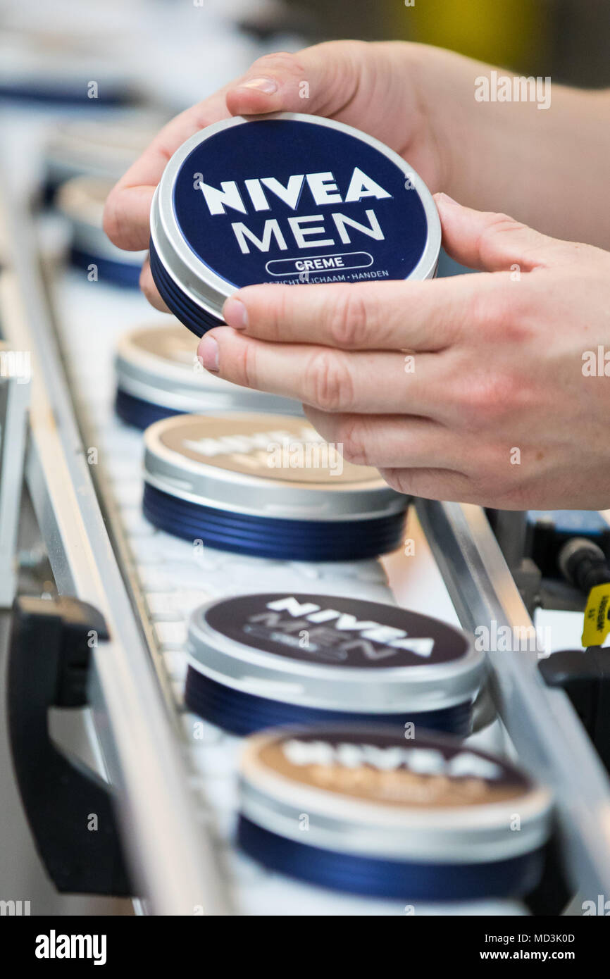 18 April 2018, Germany, Hamburg: An employee checks a Nivea-Creme of 