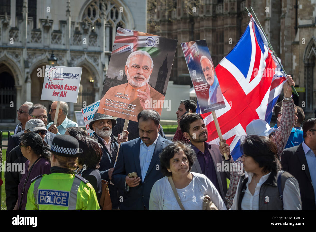 London, UK. 18th April, 2018. Modi supporters demonstrate with flags and placards near Westminster Abbey welcoming Narendra Modi, the current serving Prime Minister of India, who is visiting London as part of the Commonwealth Heads of Government summit. Credit: Guy Corbishley/Alamy Live News Stock Photo