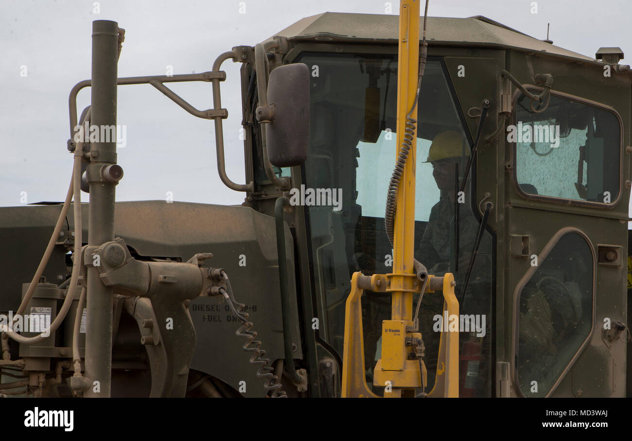 U.S. Marine Corps Pfc. Myles Bautista, a heavy equipment operator with Marine Wing Support Squadron 272, operates a 120m road grader during airfield maintenance in support of Weapons and Tactics Instructor Course (WTI) 2-18 at STOVAL Expeditionary Airfield, Dateland, Ariz., March 16, 2018. WTI is a seven-week training event hosted by Marine Aviation Weapons and Tactics Squadron One (MAWTS-1) cadre, which emphasizes operational integration of the six functions of Marine Corps aviation in support of a Marine Air Ground Task Force and provides standardized advanced tactical training and certifica Stock Photo