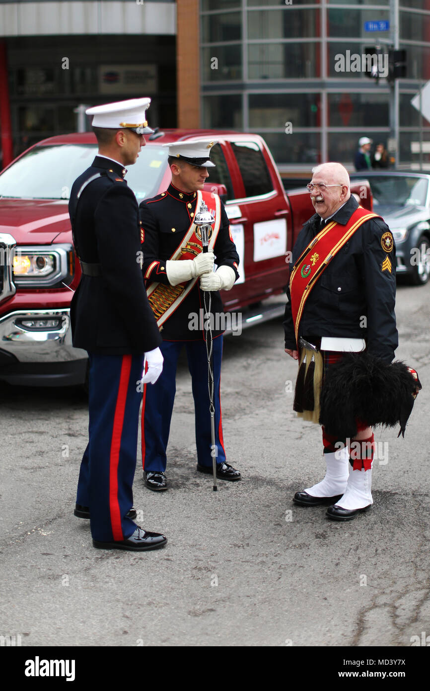 Marines with the 3rd Marine Aircraft Wing band interact with parade participants prior to the Pittsburgh St. Patrick’s Day Parade, March 17. The 3rd MAW band’s presence at high-visibility events allows positive interaction with the public and assists in recruiting efforts across the country. (U.S. Marine Corps photo by Sgt. David Bickel/Released) Stock Photo
