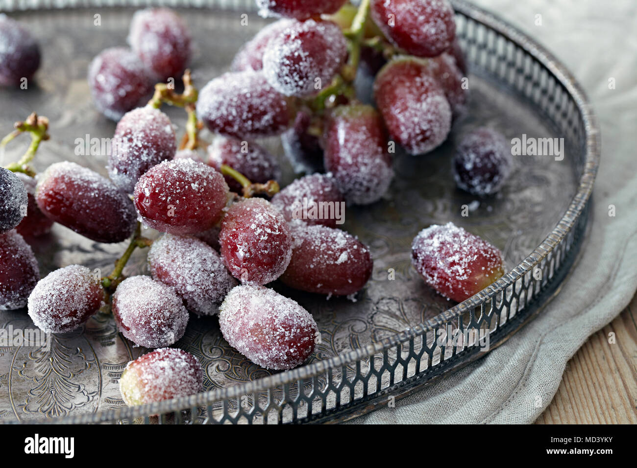 Sugar frosted black grapes on tray Stock Photo