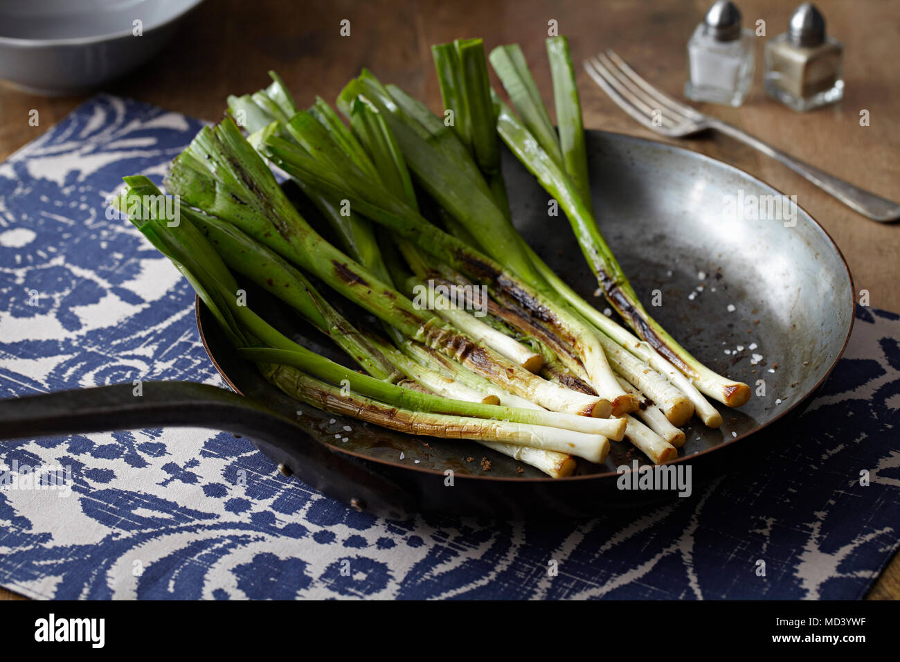Caramelised baby leeks in frying pan Stock Photo Alamy