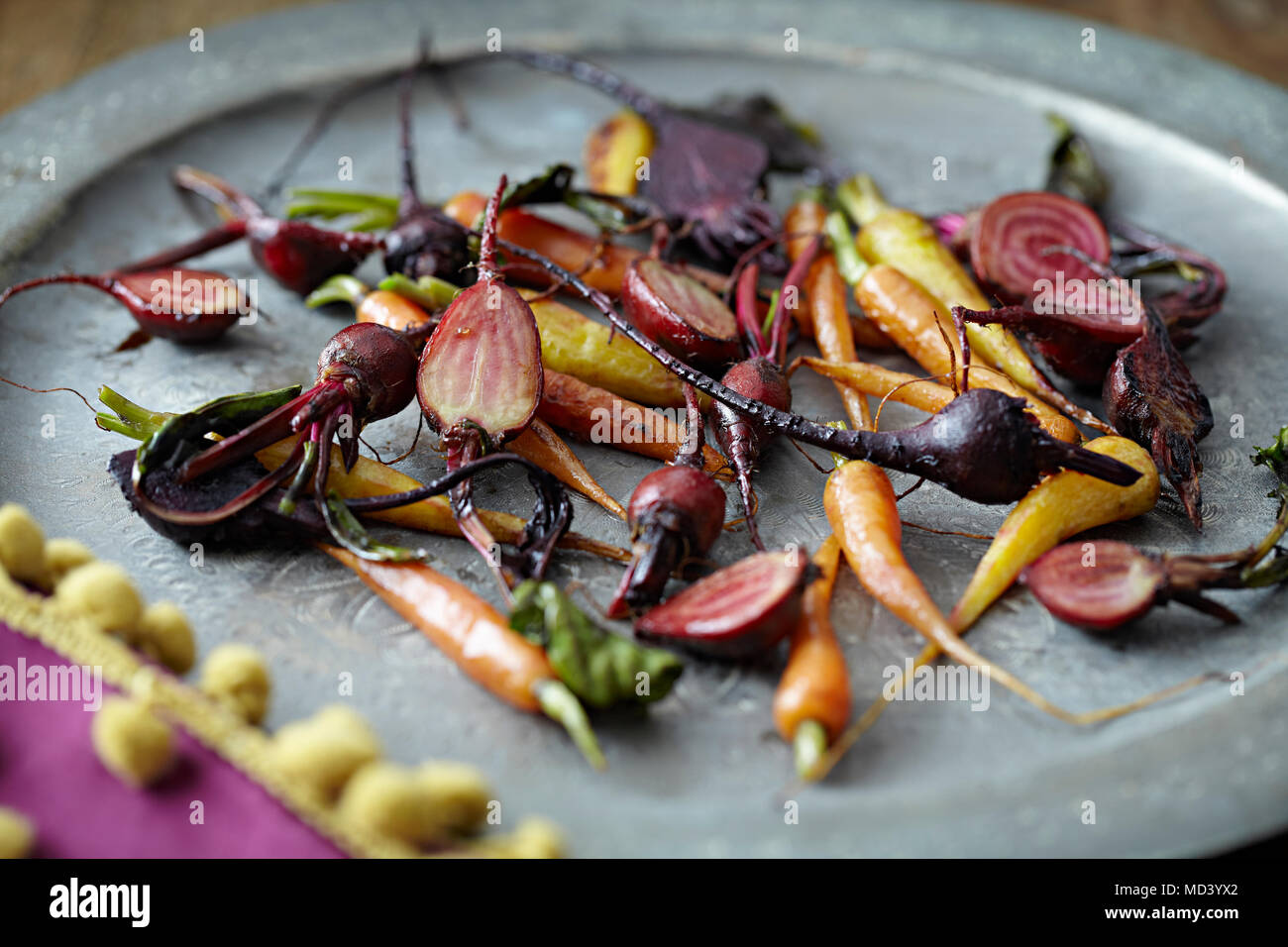 Roasted baby vegetables on tray Stock Photo Alamy