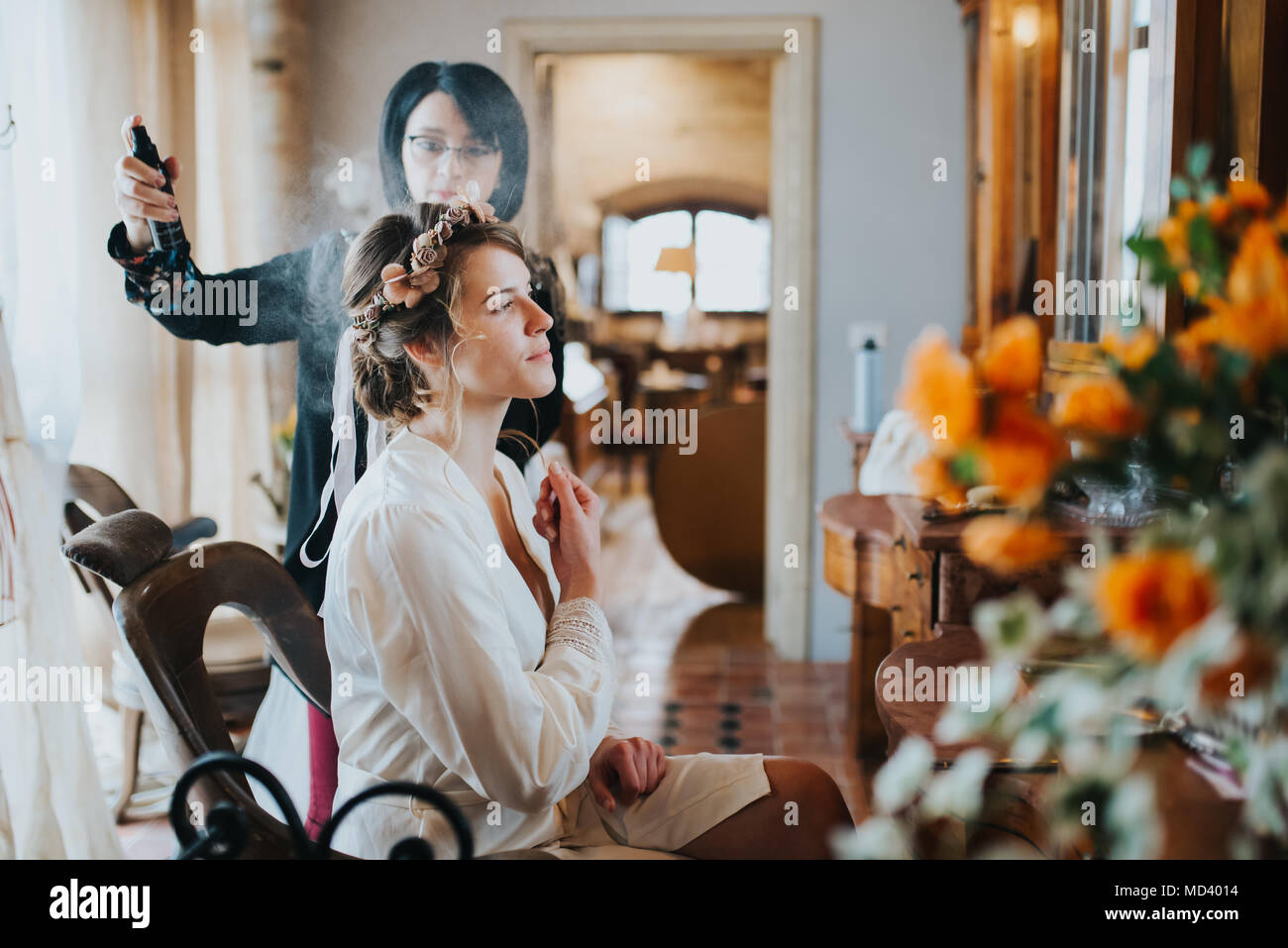 Bride preparing for wedding with hairstylist Stock Photo