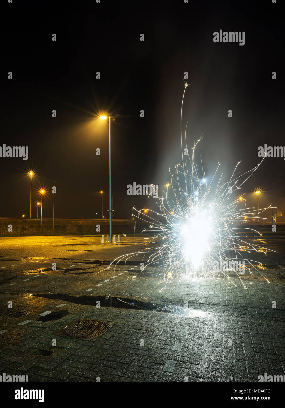 Fireworks going off in a car park, on new years eve, Heerenveen, Friesland, Netherlands Stock Photo
