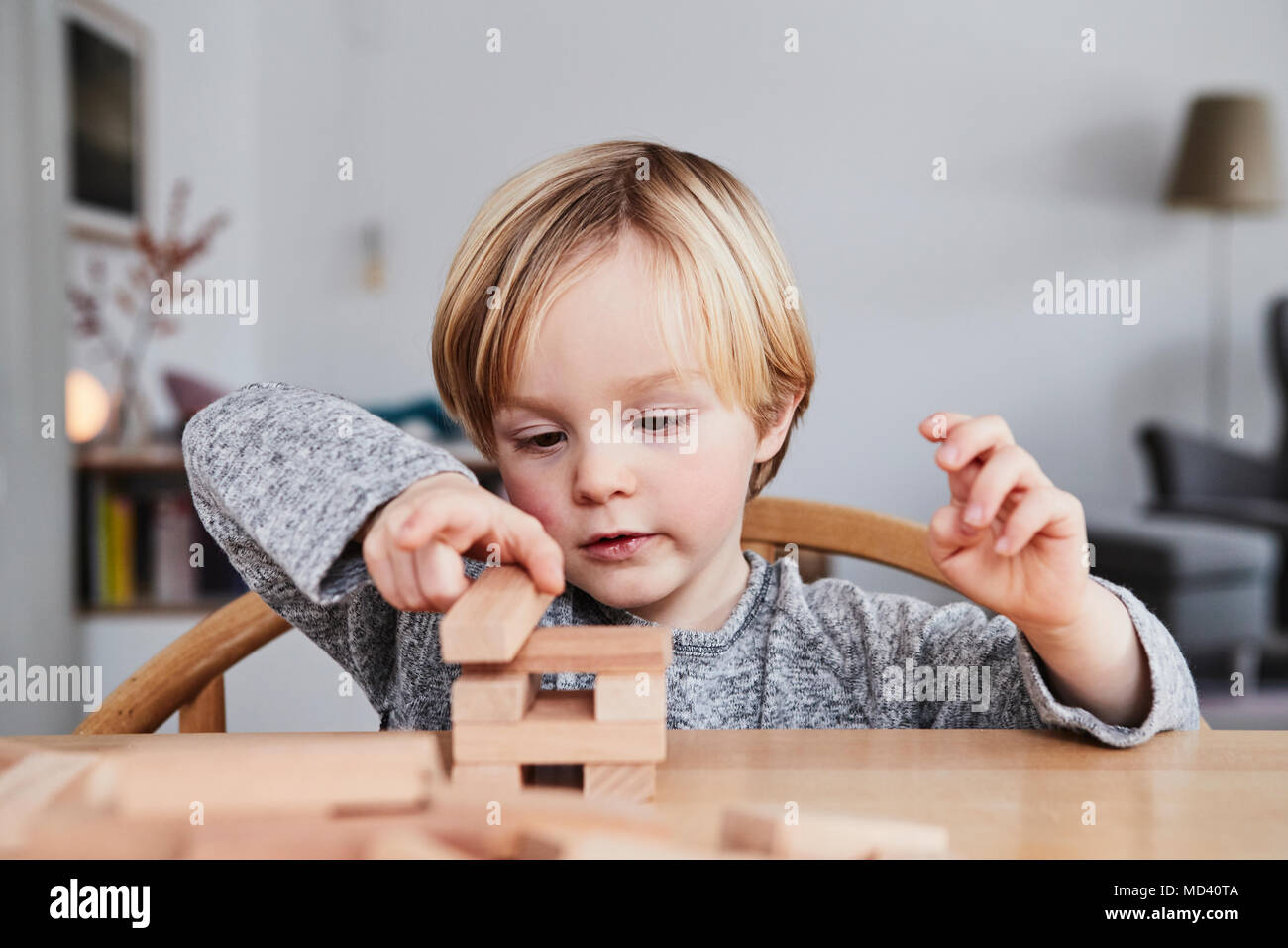 Portrait of young boy, building structure with wooden building blocks Stock Photo