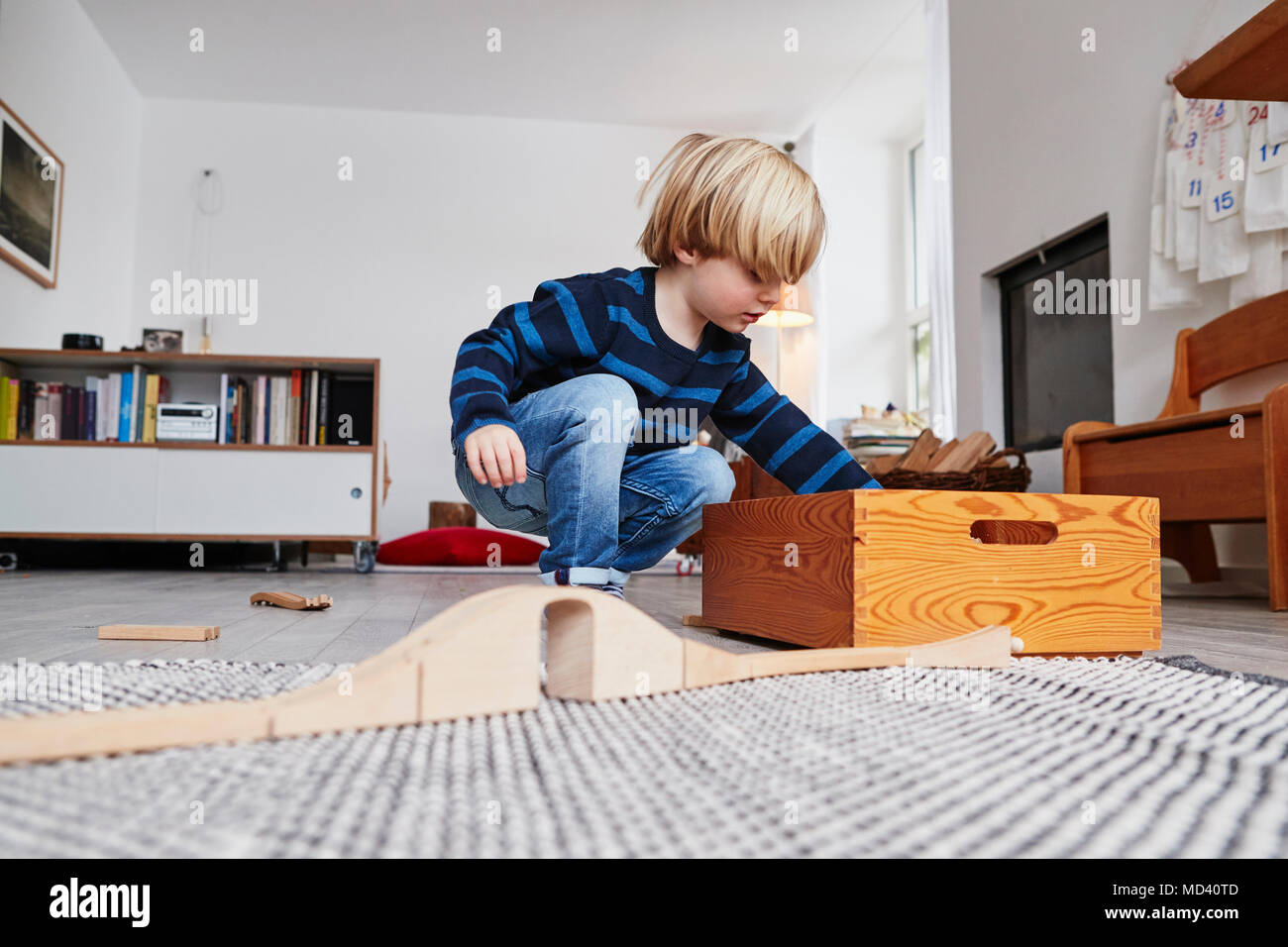 Young boy playing with toys in living room, low angle view Stock Photo