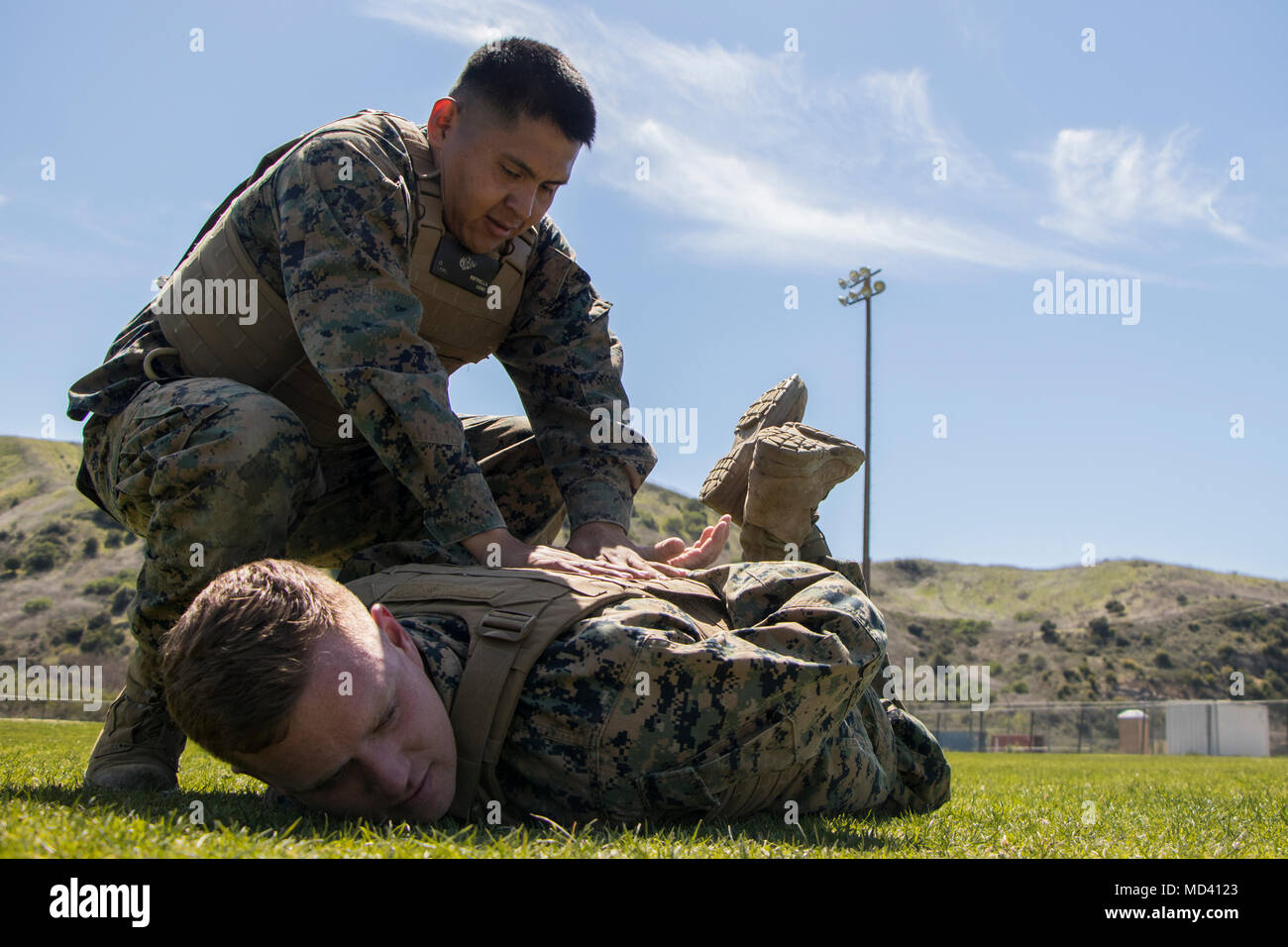 U.S. Marine Corps Lance Cpl. Oscar Estrella with Marine Aviation Logistics Squadron 39 (MALS-39) holds down Lance. Cpl. Izaak Long with Marine Aviation Logistics Squadron 39 (MALS-39), during a Marine Corps Martial Arts Program (MCMAP) session on Camp Pendleton, Calif., March 19, 2018. MCMAP teaches Marines the fundamentals of hand-to-hand combat, ground fighting and self-defense techniques. (U.S. Marine Corps photo by Cpl. Andre Heath) Stock Photo