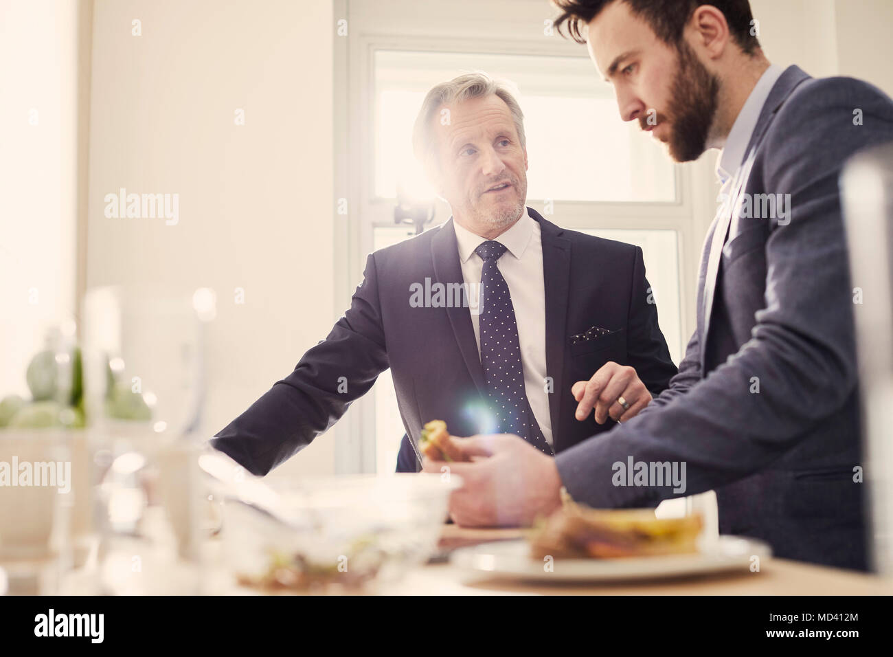 Businessmen meeting over working lunch Stock Photo Alamy