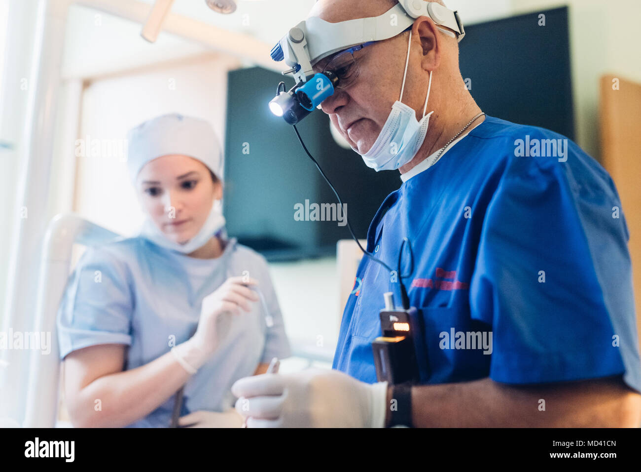 Dentist wearing dental binocular loupes Stock Photo Alamy