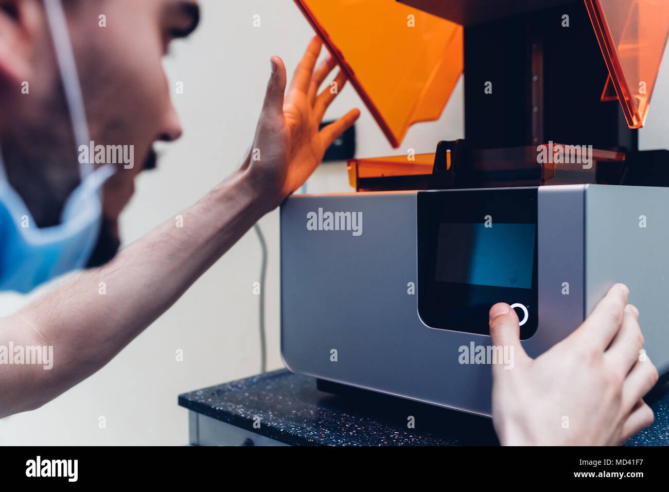Male dentist using 3D printer Stock Photo