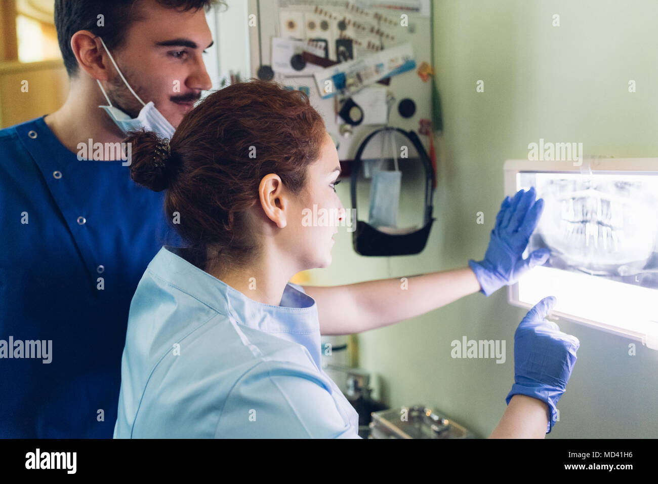 Two dentists in dentist office, looking at dental x-ray Stock Photo