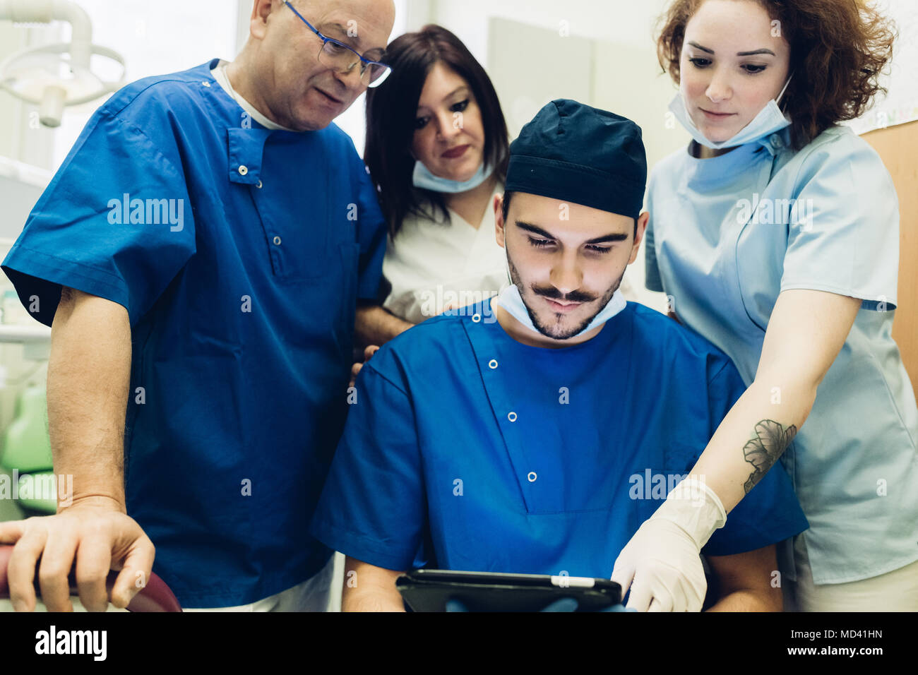 Dentists in dentist office looking at digital tablet Stock Photo