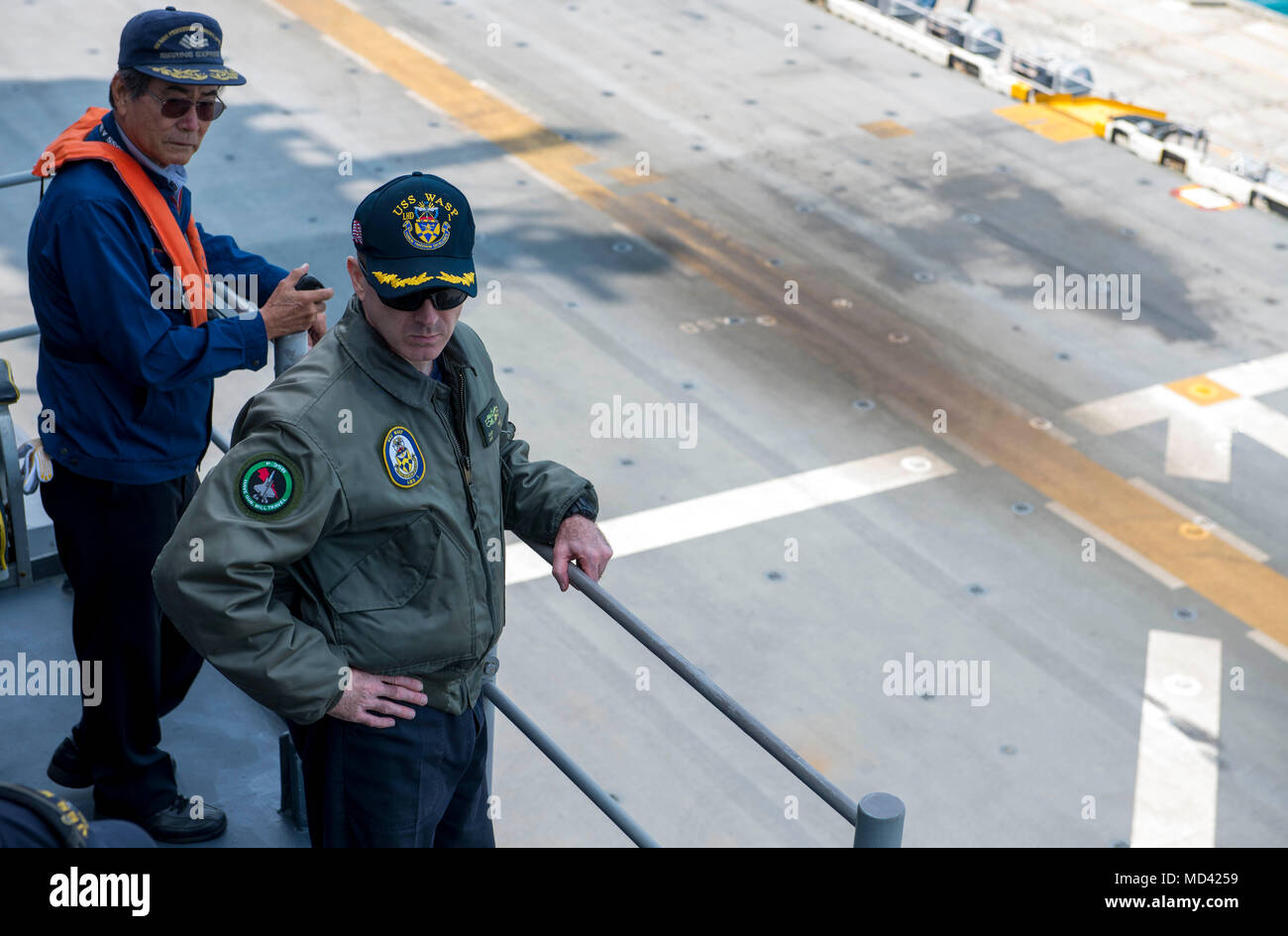 180319-N-VK310-0009 OKINAWA, Japan (March 19, 2018) Capt. John Howard, Commanding Officer of the amphibious assault ship USS Wasp (LHD 1), takes charge during the ship's departure from Okinawa. Wasp, part of the Wasp Expeditionary Strike Group, with embarked 31st Marine Expeditionary Unit, is operating in the Indo-Pacific region to enhance interoperability with partners, serve as a ready-response force for any type of contingency, and advance the Up-Gunned ESG concept. (U.S. Navy photo by Mass Communication Specialist 3rd Class Michael Molina/Released) Stock Photo