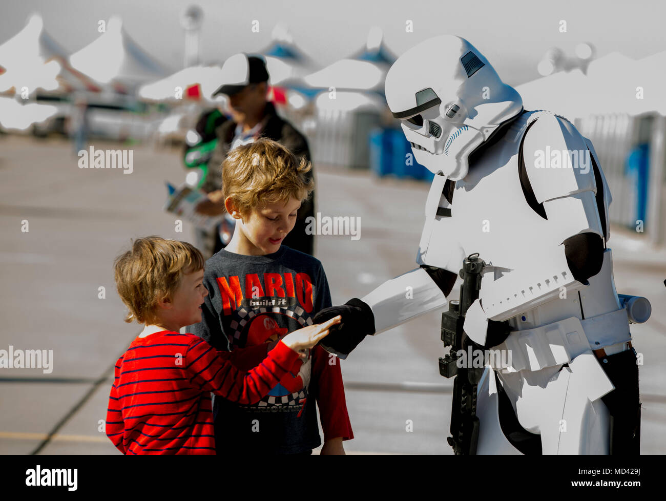 Guests interact with a Stormtrooper at the 2018 Yuma Airshow hosted by Marine Corps Air Station Yuma, Ariz., Saturday, March 17, 2018. The airshow is MCAS Yuma's only military airshow of the year and provides the community an opportunity to see thrilling aerial and ground performers for free while interacting with Marines and Sailors. (U.S. Marine Corps photo by Lance Cpl. Sabrina Candiaflores) Stock Photo