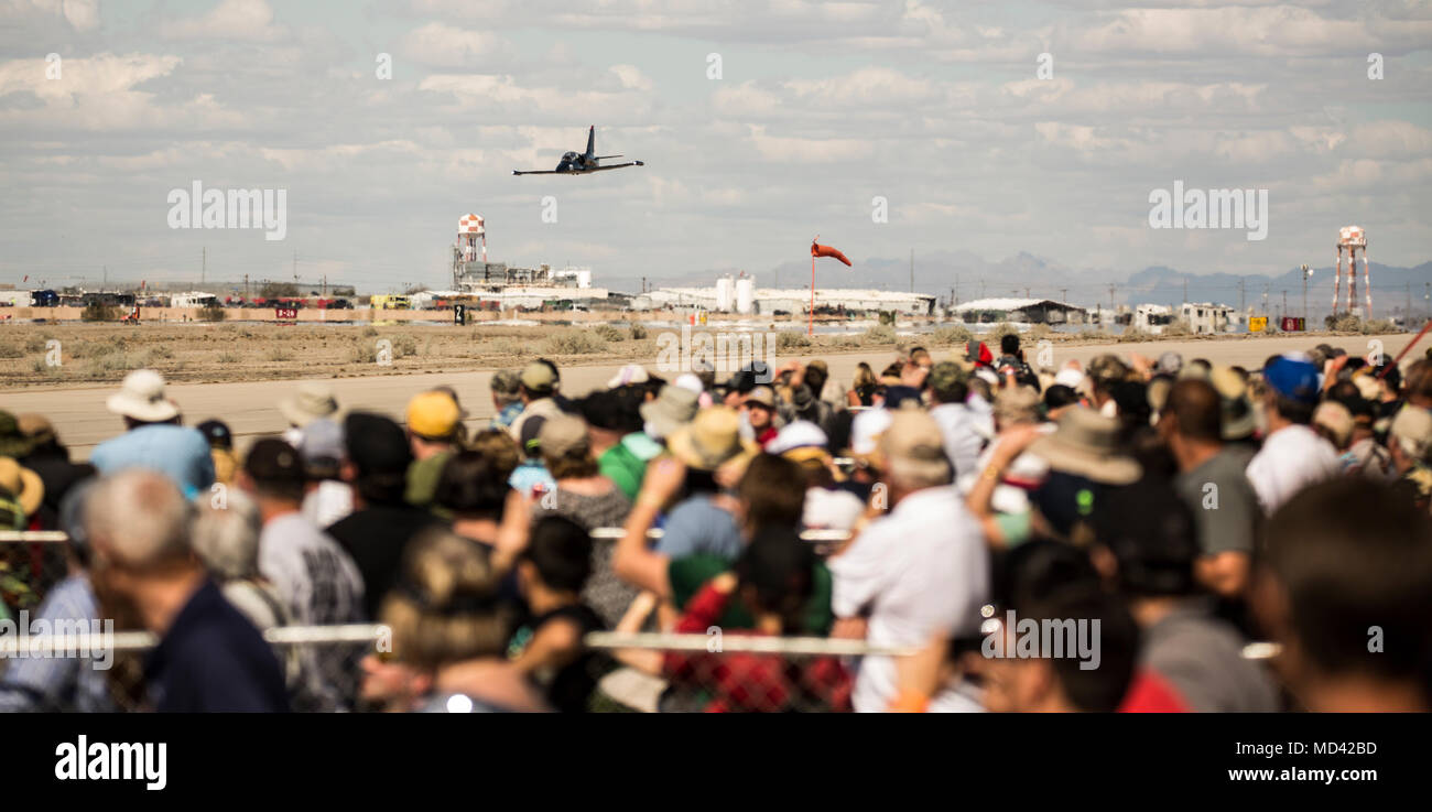 Spectators watch as the Air Force's F-22 'Raptor' performs an aerial routine during the 2018 Yuma Airshow hosted by Marine Corps Air Station Yuma, Ariz., Saturday, March 17, 2018. The airshow is MCAS Yuma's only military airshow of the year and provides the community an opportunity to see thrilling aerial and ground performers for free while interacting with Marines and Sailors. (U.S. Marine Corps photo by Lance Cpl. Sabrina Candiaflores) Stock Photo