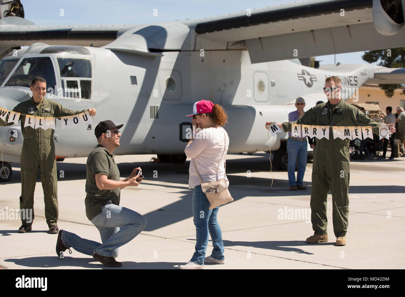 A guest attending the 2018 Yuma Airshow proposes to a woman at Marine Corps Air Station Yuma, Ariz., Saturday, March 17, 2018. The airshow is MCAS Yuma's only military airshow of the year and provides the community an opportunity to see thrilling aerial and ground performers for free while interacting with Marines and Sailors. (U.S. Marine Corps photo by Lance Cpl. Sabrina Candiaflores) Stock Photo