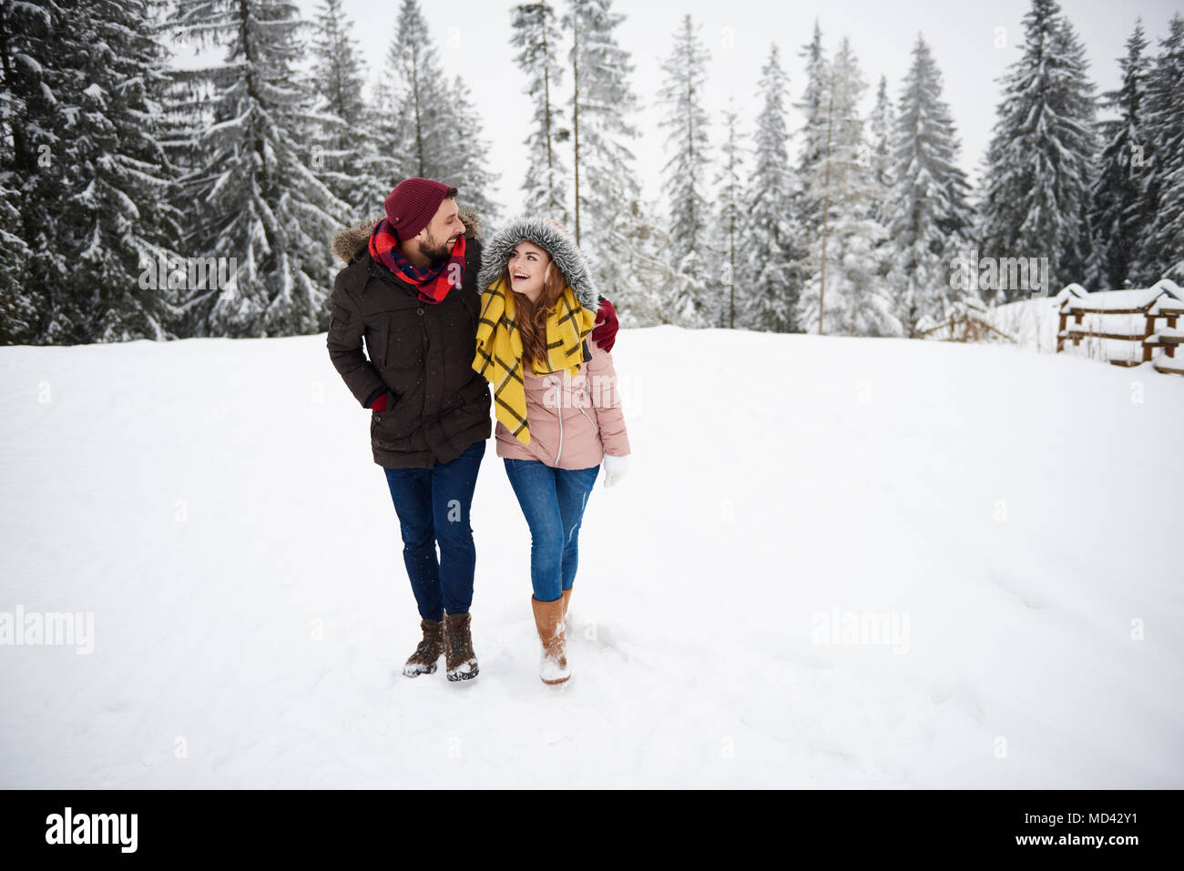 Young couple walking in snow Stock Photo