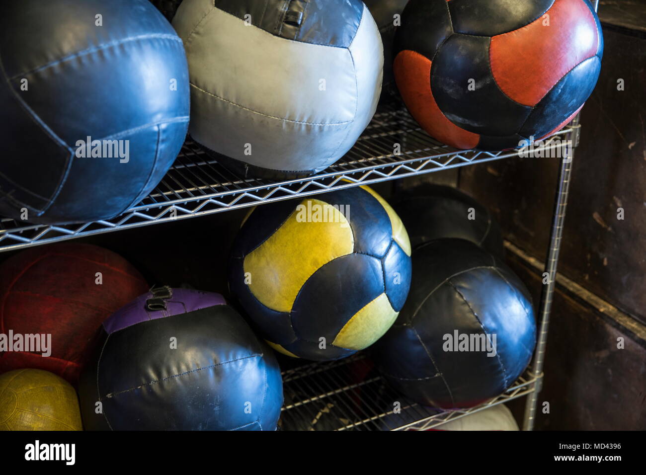 Medicine balls on metal shelf in gym, close-up Stock Photo