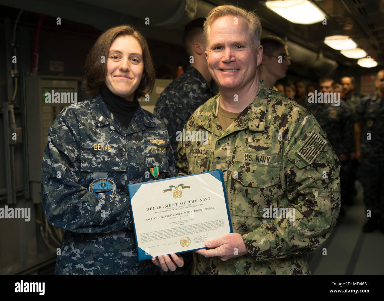 NORFOLK, Va. (Mar. 20, 2018) -- Lt. j.g. Mary Benke, assigned to USS Gerald R. Ford's (CVN 78) intelligence department, receives a Navy and Marine Corps Achievement Medal certificate from Capt. Richard McCormack, Ford's commanding officer. (U.S. Navy photo by Mass Communication Specialist 3rd Class Ryan Carter) Stock Photo