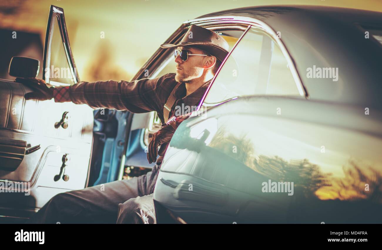 American Classic Muscle Car Cowboy Driver in His 30s. Wester Wear Outlaw Style. Stock Photo