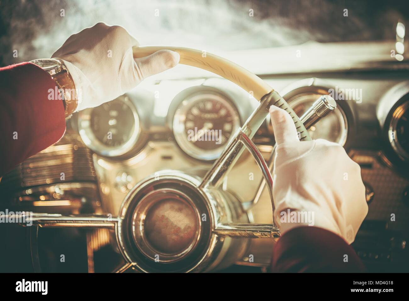 Classic Retro Car Driver. Men in White Gloves Driving His Vintage Vehicle. Steering Wheel Closeup. Stock Photo