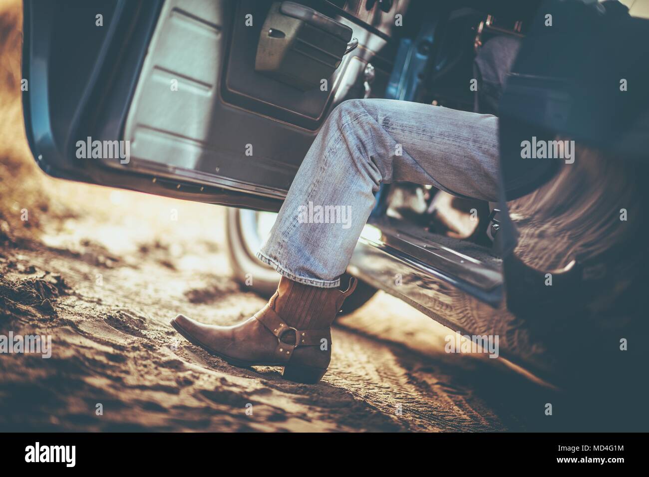 Cowboy and the Classic Muscle Car Taking a Ride. Cowboy Shoes. Leather Boot. Stock Photo