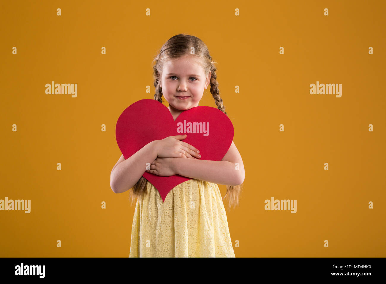 Front portrait of happy young girl holding big red heart Stock Photo ...