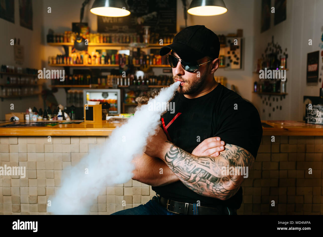 The man smoke an electronic cigarette at the vape shop Stock Photo - Alamy The man smoke an electronic cigarette at the vape shop Stock Photo - Alamy
