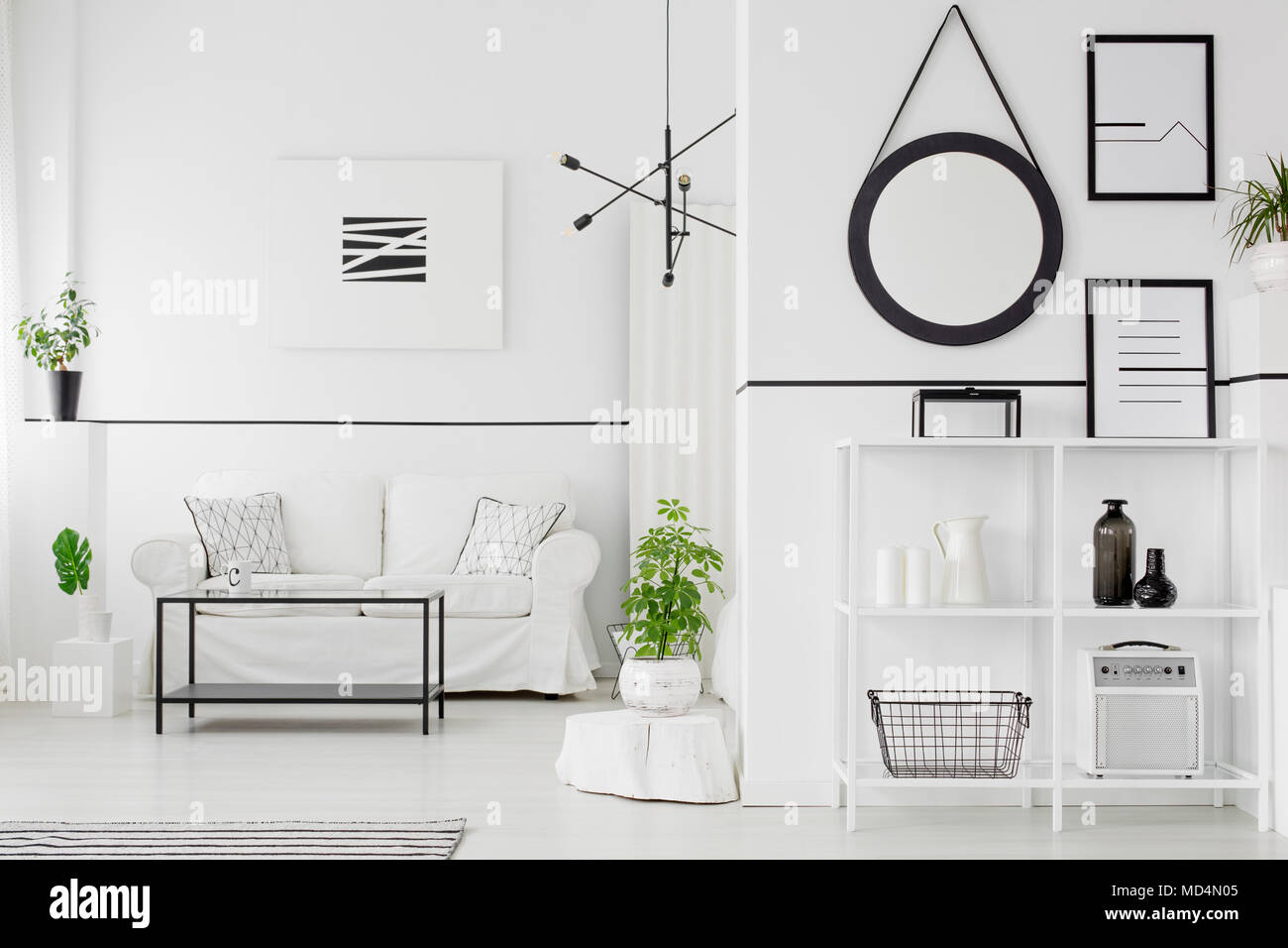 Black and white living room interior with couch, table, shelves