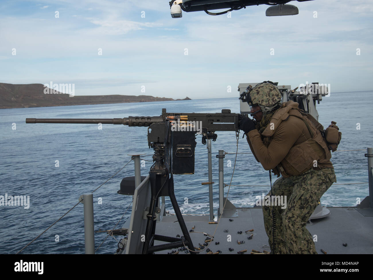 180321-N-NT795-304 SAN CLEMENTE ISLAND, Calif. (March 21, 2018) Boatswain’s Mate 2nd Class Ralphaell Punch, a native of Mount Union, Philadelphia assigned to Coastal Riverine Squadron (CRS) 3, fires a .50-caliber machine gun aboard MKVI patrol boat during a live fire exercise as part of unit level training provided by Coastal Riverine Group (CRG) 1 Training and Evaluation Unit. CRG provides a core capability to defend designated high value assets throughout the green and blue-water environment and providing deployable Adaptive Force Packages (AFP) worldwide in an integrated, joint and combined Stock Photo