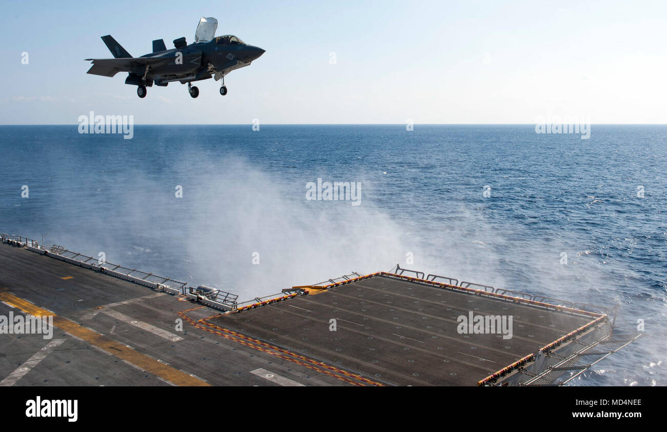 180323-N-VK310-0013 PHILIPPINE SEA (March 23, 2018) An F-35B Lightning II lands on the flight deck of the amphibious assault ship USS Wasp (LHD 1). Wasp, part of the Wasp Expeditionary Strike Group, with embarked 31st Marine Expeditionary Unit, is operating in the Indo-Pacific region to enhance interoperability with partners, serve as a ready-response force for any type of contingency and advance the Up-Gunned ESG Concept. (U.S. Navy photo by Mass Communication Specialist 3rd Class Michael Molina/Released) Stock Photo